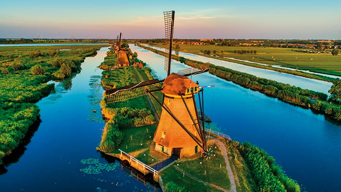 The Kinderdijk windmills in the Netherlands, with static wording reading '2025 river cruises'